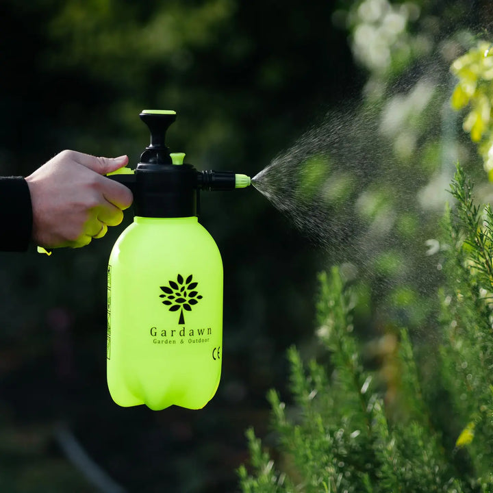 Gardener using the 2L sprayer to mist plants