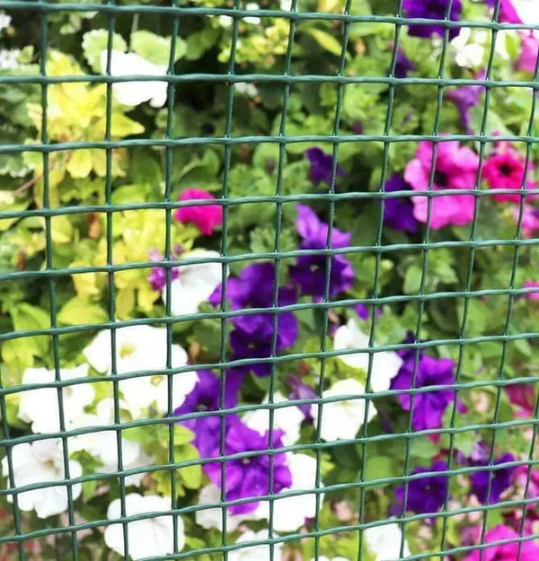 Plastic mesh garden fencing with decorative flowers entwined